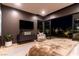 Main bedroom with a seating area, a TV, and views of the outdoor landscaping and the city at 720 Dragon Peak Dr, Henderson, NV 89012