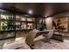 Contemporary office with modern desk, artwork, and sliding glass doors to outdoor landscaping at 720 Dragon Peak Dr, Henderson, NV 89012