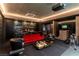 Recreation room featuring a full bar, golf simulator, comfortable seating, and modern lighting at 720 Dragon Peak Dr, Henderson, NV 89012