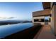 Breathtaking panoramic views from the home's infinity pool, capturing the skyline and mountains at 720 Dragon Peak Dr, Henderson, NV 89012