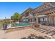 Outdoor living boasts a large pool, pergola, well-manicured yard, and an inviting patio space at 73 Kittansett Loop, Henderson, NV 89052