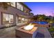 Inviting backyard featuring a fire pit, pool, and lush landscaping, perfect for relaxation at 73 Kittansett Loop, Henderson, NV 89052
