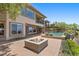 Beautiful backyard features a modern fire pit, a pool, patio space and landscaped gardens at 73 Kittansett Loop, Henderson, NV 89052