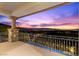 Balcony with iron railing and stone pillars showcasing expansive city views at twilight at 73 Kittansett Loop, Henderson, NV 89052