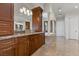 Bathroom with granite countertops, wood cabinets, and a soaking tub at 73 Kittansett Loop, Henderson, NV 89052