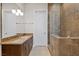 Elegant bathroom with tiled shower, granite counters and dual sinks at 73 Kittansett Loop, Henderson, NV 89052