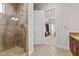 Bathroom showcasing a tiled shower with glass door at 73 Kittansett Loop, Henderson, NV 89052