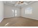 A bright, carpeted bedroom featuring custom plantation shutters at 73 Kittansett Loop, Henderson, NV 89052