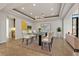 Elegant dining room with modern chandelier, glass table, and stylish decor for sophisticated dining experience at 73 Kittansett Loop, Henderson, NV 89052