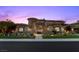 Imposing home with stone accents, manicured landscaping, and a gated courtyard at 73 Kittansett Loop, Henderson, NV 89052