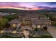 Aerial view of estate home with lush landscaping, a tile roof, and mature trees at 73 Kittansett Loop, Henderson, NV 89052