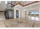Elegant foyer with elevator, staircase, decorative flooring, and an open floorplan at 73 Kittansett Loop, Henderson, NV 89052