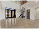 Grand foyer with high ceilings, decorative tile flooring, and an elegant wrought iron door at 73 Kittansett Loop, Henderson, NV 89052