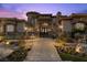 Impressive front entrance with a stone pathway, gate, and lush landscaping at 73 Kittansett Loop, Henderson, NV 89052