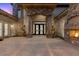 Elegant front entry with stone columns, arched entrance, and ornate iron doors at 73 Kittansett Loop, Henderson, NV 89052