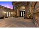 Beautiful front entry with stone pillars, arched entrance, and ironwork double doors at 73 Kittansett Loop, Henderson, NV 89052