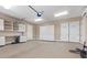Spacious garage with lots of cabinets and built-in shelving for organized storage and workspace at 73 Kittansett Loop, Henderson, NV 89052
