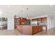 A sprawling kitchen featuring a large island, custom wood cabinets and stainless appliances at 73 Kittansett Loop, Henderson, NV 89052