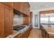 Close-up of the gourmet kitchen with granite counters, stainless steel appliances, and custom cabinetry at 73 Kittansett Loop, Henderson, NV 89052