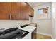 Laundry room featuring modern appliances and cabinet space for storage at 73 Kittansett Loop, Henderson, NV 89052