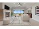 Bright living room showcasing a fireplace, neutral decor, and a scenic outdoor view at 73 Kittansett Loop, Henderson, NV 89052