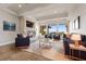 The virtually staged living room has plush seating, a cozy fireplace and a large window with a beautiful view at 73 Kittansett Loop, Henderson, NV 89052