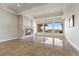 Living room featuring a fireplace, tile flooring, and a large picture window with views at 73 Kittansett Loop, Henderson, NV 89052