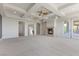 Expansive living room with fireplace, tray ceiling and outdoor access at 73 Kittansett Loop, Henderson, NV 89052