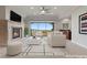 Bright living room showcasing a fireplace, neutral decor, and a scenic outdoor view at 73 Kittansett Loop, Henderson, NV 89052