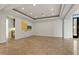 Spacious living room with recessed lighting, tray ceiling and travertine flooring at 73 Kittansett Loop, Henderson, NV 89052