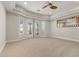Bright main bedroom with carpet, tray ceiling, ceiling fan and access to balcony at 73 Kittansett Loop, Henderson, NV 89052