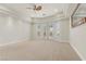 Large main bedroom with carpet, tray ceiling, ceiling fan and french doors at 73 Kittansett Loop, Henderson, NV 89052