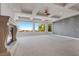 Spacious primary bedroom with a fireplace, coffered ceiling, and large windows showcasing scenic views at 73 Kittansett Loop, Henderson, NV 89052
