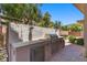 Built-in outdoor kitchen featuring a stainless steel grill and countertop prep space in backyard at 73 Kittansett Loop, Henderson, NV 89052