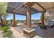 Spectacular outdoor living space with a covered patio, pool, seating, and lush tropical landscaping at 73 Kittansett Loop, Henderson, NV 89052
