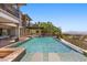 Resort-style pool has an elevated spa with seating, mature desert landscaping, and great views at 73 Kittansett Loop, Henderson, NV 89052