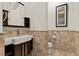 Modern powder room with stone tile and unique lighting at 73 Kittansett Loop, Henderson, NV 89052