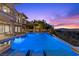 Luxury pool with an elevated spa, city views, and meticulous landscaping at 73 Kittansett Loop, Henderson, NV 89052