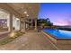 Stunning backyard featuring a pool, covered patio, and breathtaking city views at 73 Kittansett Loop, Henderson, NV 89052