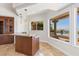 Stylish wet bar with granite countertop and outdoor view at 73 Kittansett Loop, Henderson, NV 89052