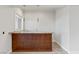 Stylish wet bar with sleek countertop and wooden cabinetry at 73 Kittansett Loop, Henderson, NV 89052