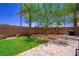 Enjoy the outdoor living space featuring a brick patio, lawn, and mature landscaping in this backyard at 7733 Harthill Park Ave, Las Vegas, NV 89113