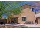 This backyard has a small lawn and a brick patio with outdoor seating and a built-in barbecue at 7733 Harthill Park Ave, Las Vegas, NV 89113