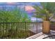 Cozy balcony offering neighborhood views framed by lush trees under a colorful sky at 7733 Harthill Park Ave, Las Vegas, NV 89113