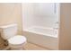 Clean bathroom with white tiled shower-tub combo and a modern toilet at 7733 Harthill Park Ave, Las Vegas, NV 89113
