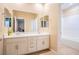 Bright bathroom with double sinks, white cabinetry, and a view into the shower and toilet area at 7733 Harthill Park Ave, Las Vegas, NV 89113