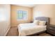 Cozy bedroom featuring a comfortable bed, side tables, and soft lighting at 7733 Harthill Park Ave, Las Vegas, NV 89113