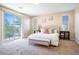 Sunlit bedroom with balcony, comfortable bed, and stylish decor with a relaxing atmosphere at 7733 Harthill Park Ave, Las Vegas, NV 89113