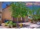Charming two-story home features a two-car garage, stone accents, and a well-manicured front yard at 7733 Harthill Park Ave, Las Vegas, NV 89113