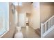 Welcoming foyer with tile flooring, staircase, and neutral color scheme at 7733 Harthill Park Ave, Las Vegas, NV 89113